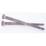 Two Indian relief embossed silver parasol handles, length 27cm.
