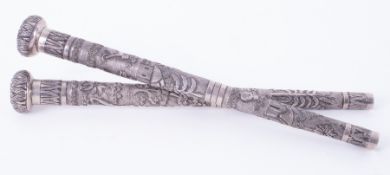 Two Indian relief embossed silver parasol handles, length 27cm.