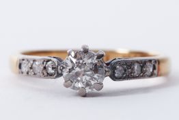 An 18ct yellow gold & platinum ring set with a round cut diamond, approx. 0.50 carats with three