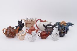 A collection of various novelty teapots (9).