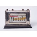 A silver faced adjustable desk calendar, height 14cm, width 22cm.