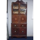 An Edwardian mahogany side cabinet, the upper section fitted with a pair of glazed door, over a 2