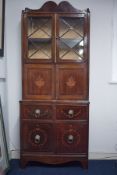 An Edwardian mahogany side cabinet, the upper section fitted with a pair of glazed door, over a 2