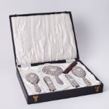 A five piece silver back dressing table set, cased.