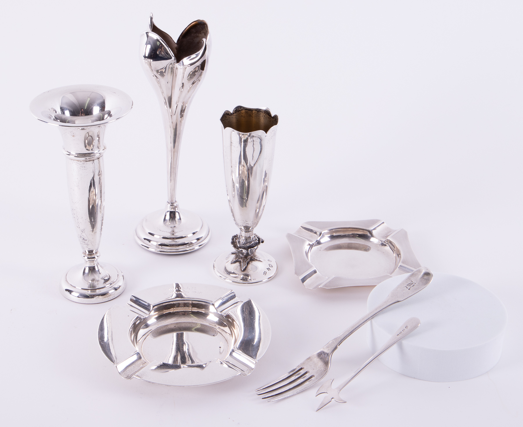 Two silver ashtrays, fork, three silver vases, the tallest 20cm etc (7).