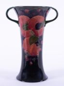 A William Moorcroft twin handled Burslem vase decorated with Pomegranate, also decorated inside,