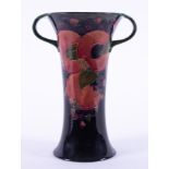 A William Moorcroft twin handled Burslem vase decorated with Pomegranate, also decorated inside,