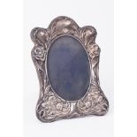 A silver photo frame with Art Nouveau with embossed decoration, height 19cm.