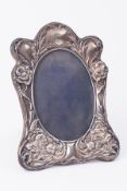 A silver photo frame with Art Nouveau with embossed decoration, height 19cm.