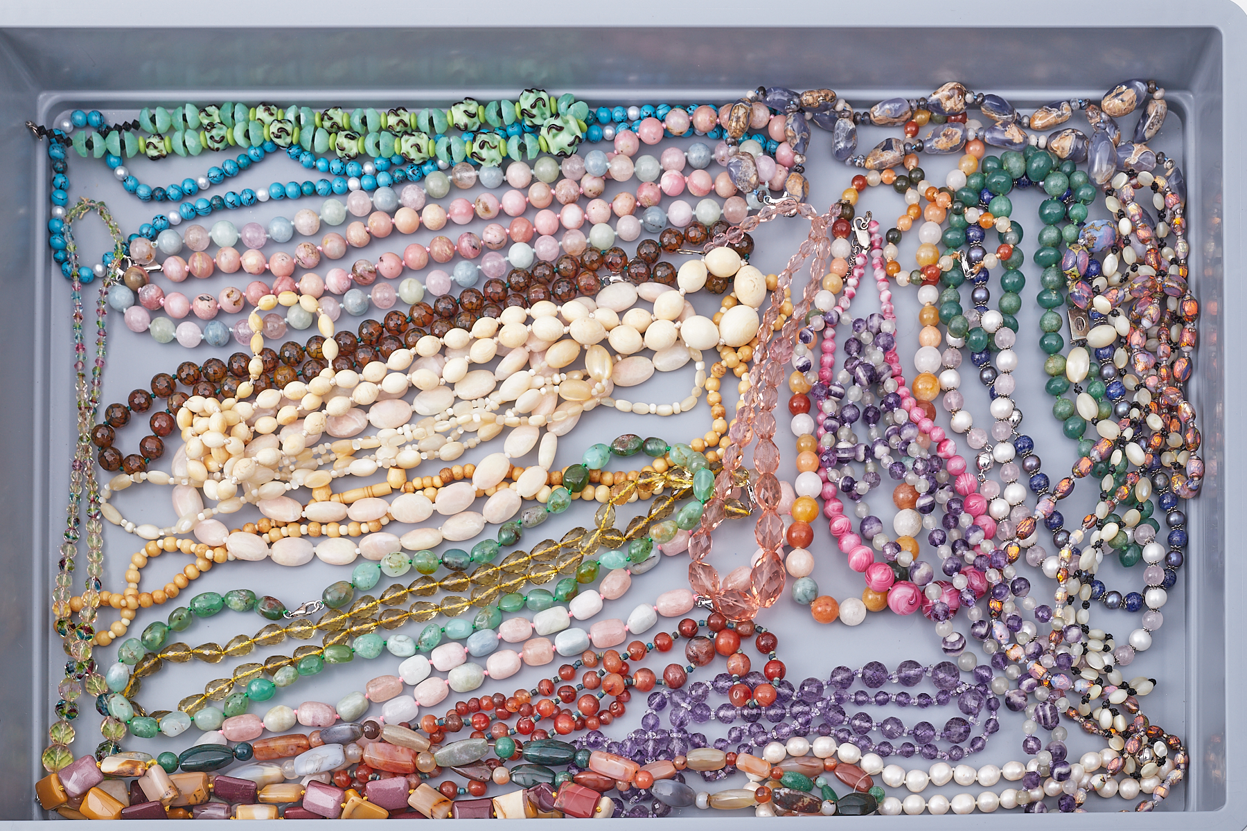 A large mixed lot of mainly semi-precious beads to include monazite, green quartz, pink opals,