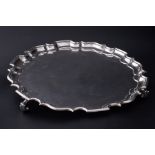 A silver salver on curl feet, makers mark T B, London, diameter 35cm, approx 43oz.