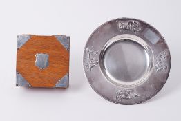 A silver mounted square oak cigarette box together with a continental (925) child's plate (artist