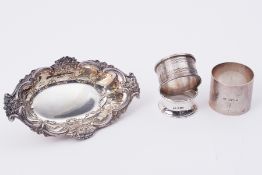 Two silver napkin rings (1.95oz) unmarked silver effect dish and napkin ring (4).