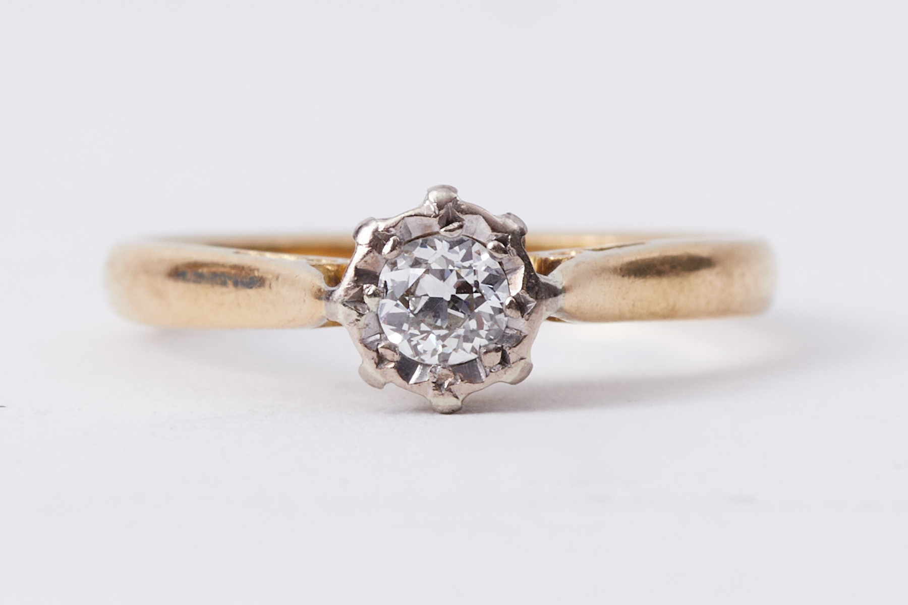 An 18ct yellow gold single stone ring set with a round cut diamond in an illusion setting, approx.