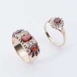 Two rings to include a 9ct yellow gold cluster ring set with an oval cut garnet and surrounded by