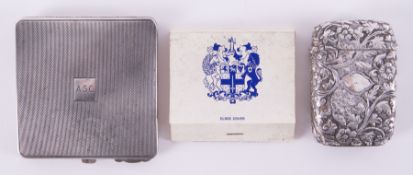 A silver square compact monogramed 'ACS' and a ornate vesta decorated with flowers (not