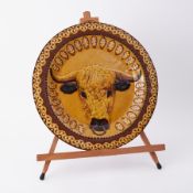 Jean Hampton, a studio pottery slipware dish signed and dated '73' a bull, diameter 40cm.
