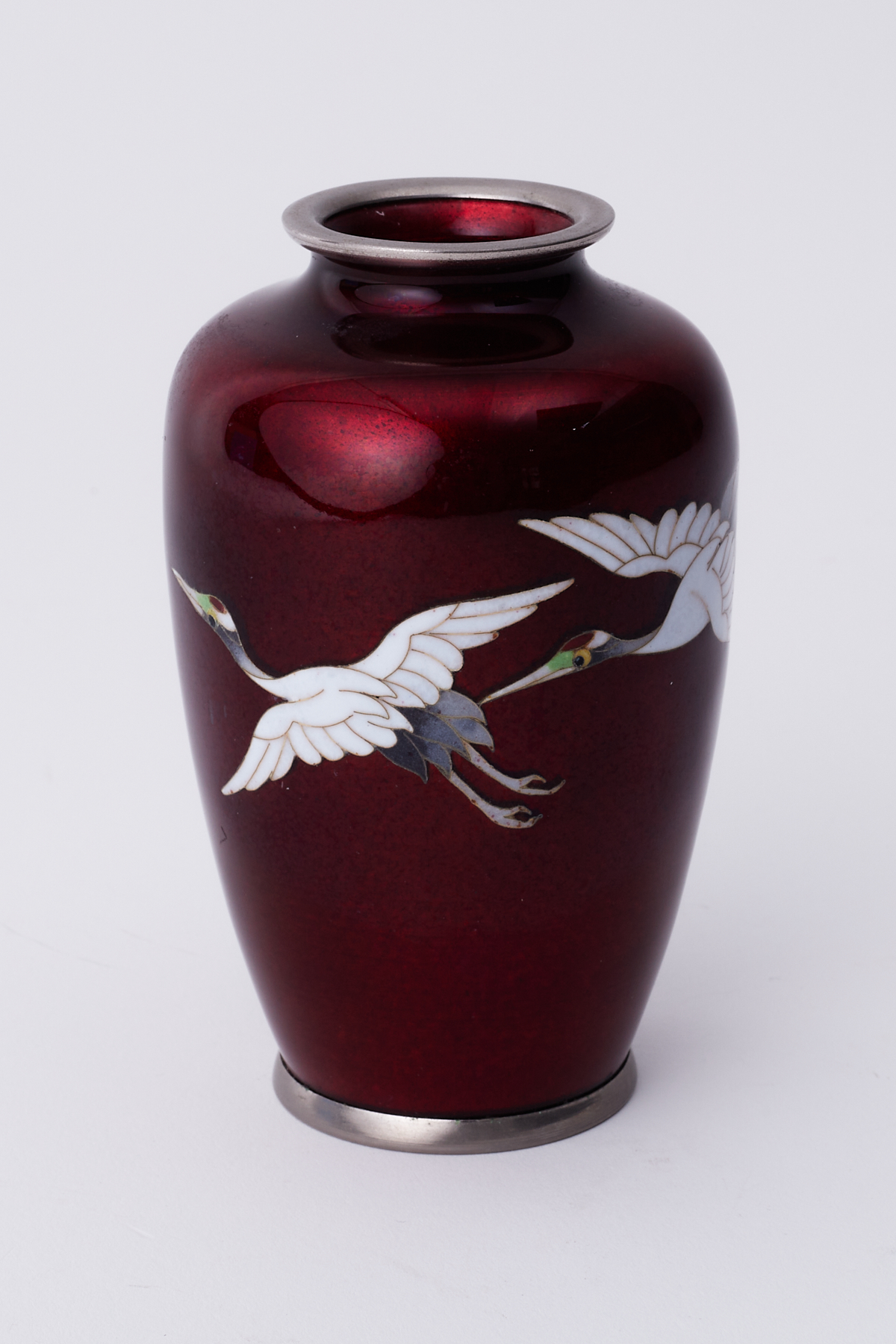 A 20th century cloisonné small enamelled vase decorated flying cranes, height 13cm.