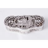 An Edwardian silver box by William Comyns, London 1903/04, of shaped form, the pierced hinged