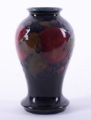 A William Moorcroft miniature baluster vase decorated with Pomegranate.