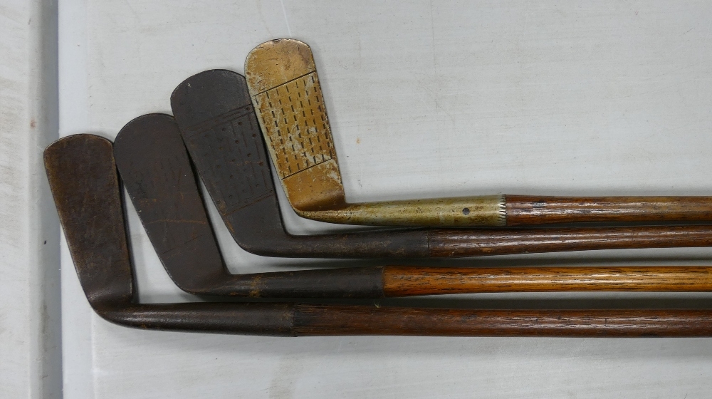 A collection of Vintage Golf Clubs: including 4 Hickory Shafted items, woods, putters etc
