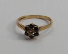 9ct gold ladies ring, 2g: one blue stone missing.