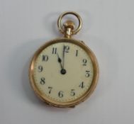 A 14ct gold cased lades fob watch: Measures 32mm wide, base metal inner dust case. Winds & ticks.
