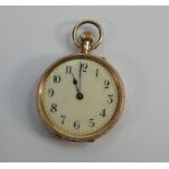 A 14ct gold cased lades fob watch: Measures 32mm wide, base metal inner dust case. Winds & ticks.
