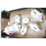 A collection of Ceramic Novelty Pig Money Boxes with Floral decoration: