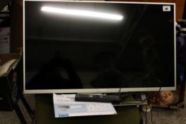 A Sony Bravia TV: model KDL-32WD752, with remote and instruction guide.