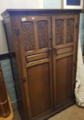 A quality early/mid 20th century carved dark oak gentleman's double wardrobe: 98cm wide x 154cm