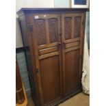 A quality early/mid 20th century carved dark oak gentleman's double wardrobe: 98cm wide x 154cm