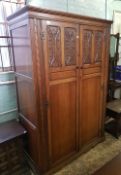 A quality early/mid 20th century carved dark oak double wardrobe: 127cm wide x 188cm high.