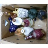 A collection of Ceramic Empty Whiskey Decanters including: John Mcdonalds, Bells, Dimple, Findlaters