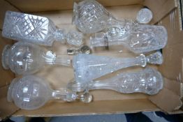 A collection of 7 cut glass decanters: some with Royal Addereley pottery name plates