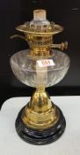 An Edwardian brass and glass oil lamp: no shade or chimney, 40cm in height.