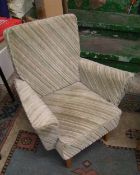 A mid century child's armchair: raised on teak supports.