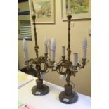 A pair of mid century French Empire style ormolu table lamps: with Putti detail on circular marble