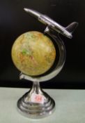 A metal mounted globe with areoplane: