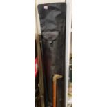 Three fishing rods: together with accessories and rod holdall plus a brass topped walking stick