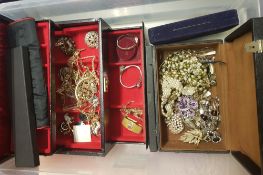 Two jewellery boxes containing a quantity of costume jewellery: brooches, bracelets, necklaces