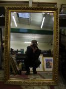 A large framed beveled edge mirror: 100cm x 69cm.