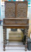 Antique carved oak two door cabinet on stand: The two doors open to reveal 10 marquetry inlaid