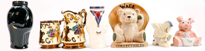 A collection of Wade pottery items: To include 2 elephant storage jars & covers, Wade teddy name