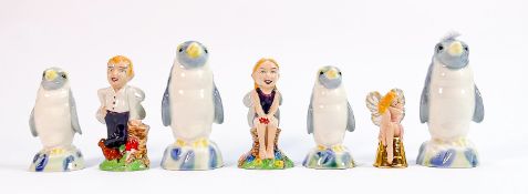 A collection of Wade figures: Including Penguin decanters and fairy figures. (7)