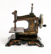 Early 20th century miniature cast iron sewing machine: Original floral painted decoration, no 99007,