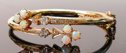 Yellow gold set opal & diamond bangle: Set with 6 good coloured opals and 14 diamonds. The 2