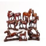 A collection of 13 early 20th century Chinese carved figures of mythical horses: Average height