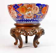 Large 19th century Japanese Imari decorated bowl on hardwood stand: Stand damaged, diameter 26cm. (