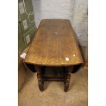 Dark oak drop leaf dining table: 120cm W x 75cm H.